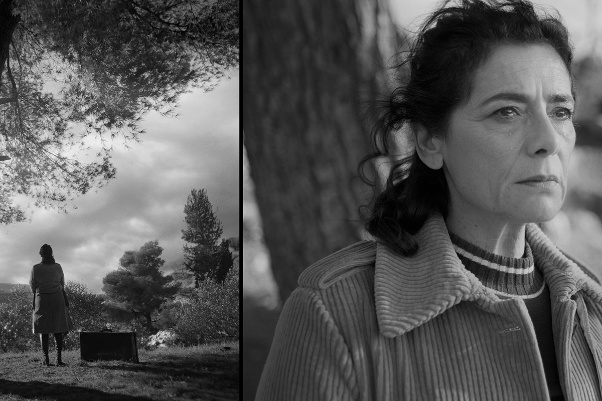 Black and White still from the film "In Vitro" shows a person standing outside next to a tree and looking off camera.