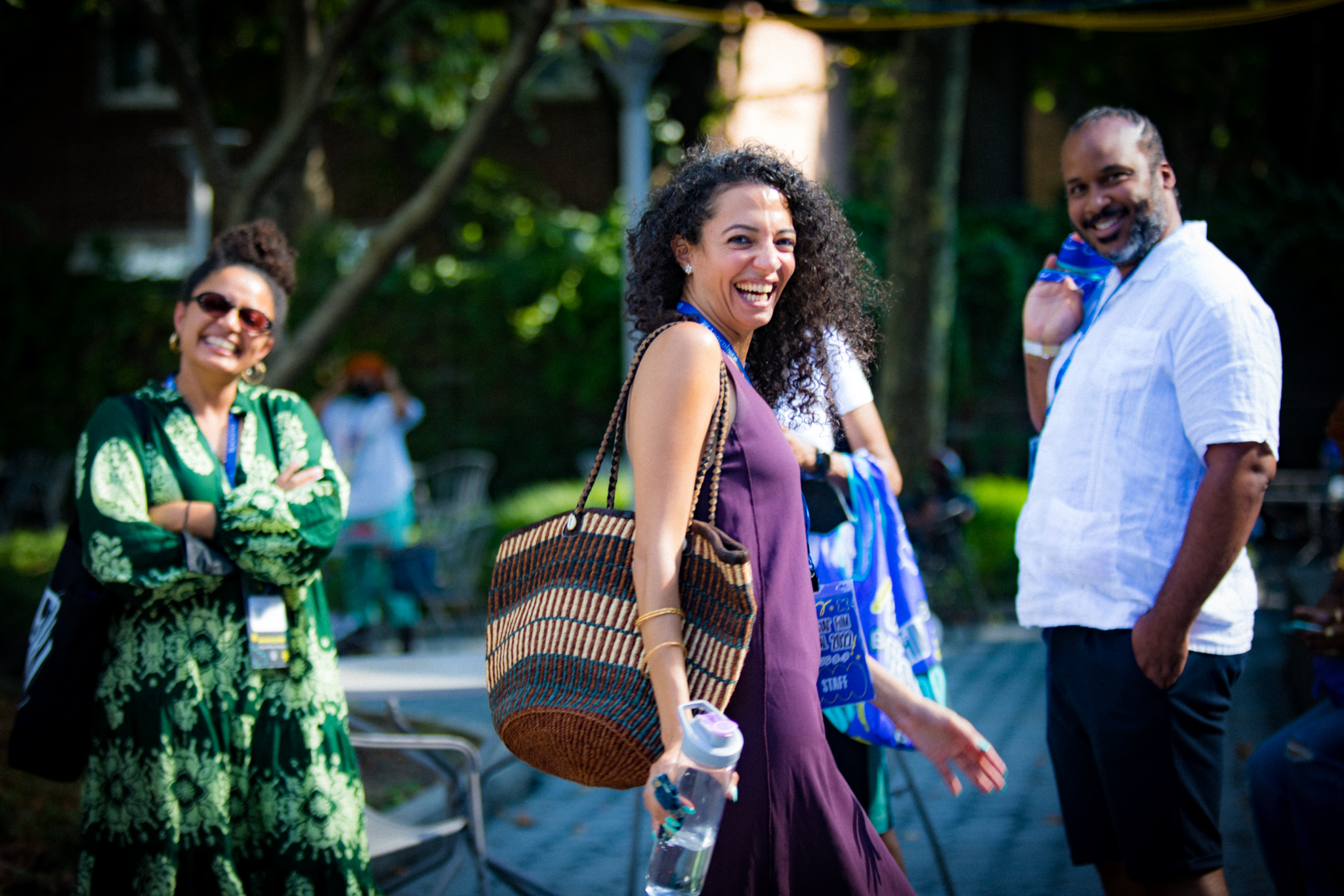 A photo of Nehad walking in the festival courtyard, she is smiling at the camera.