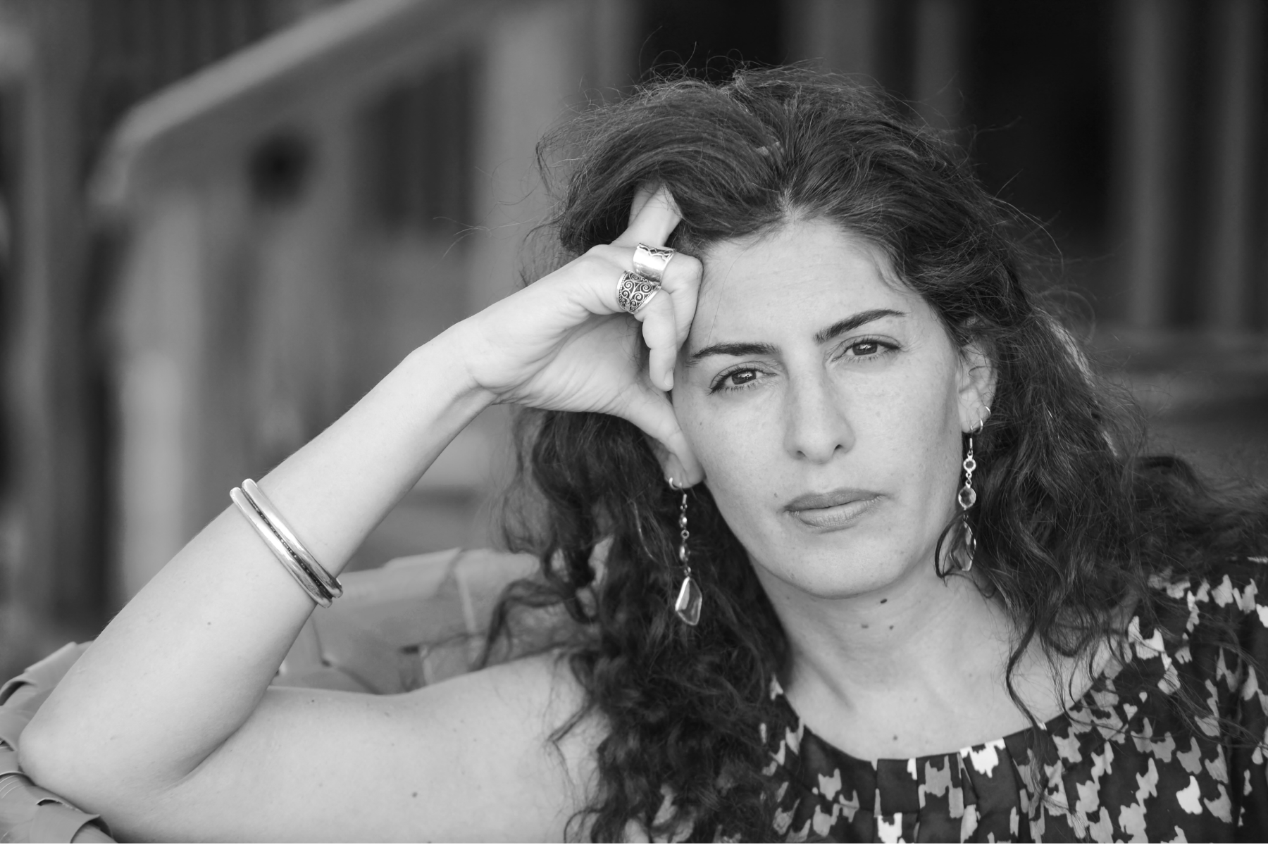 A headshot of Annemarie Jacir, looking directly at the camera with a look of intensity. 