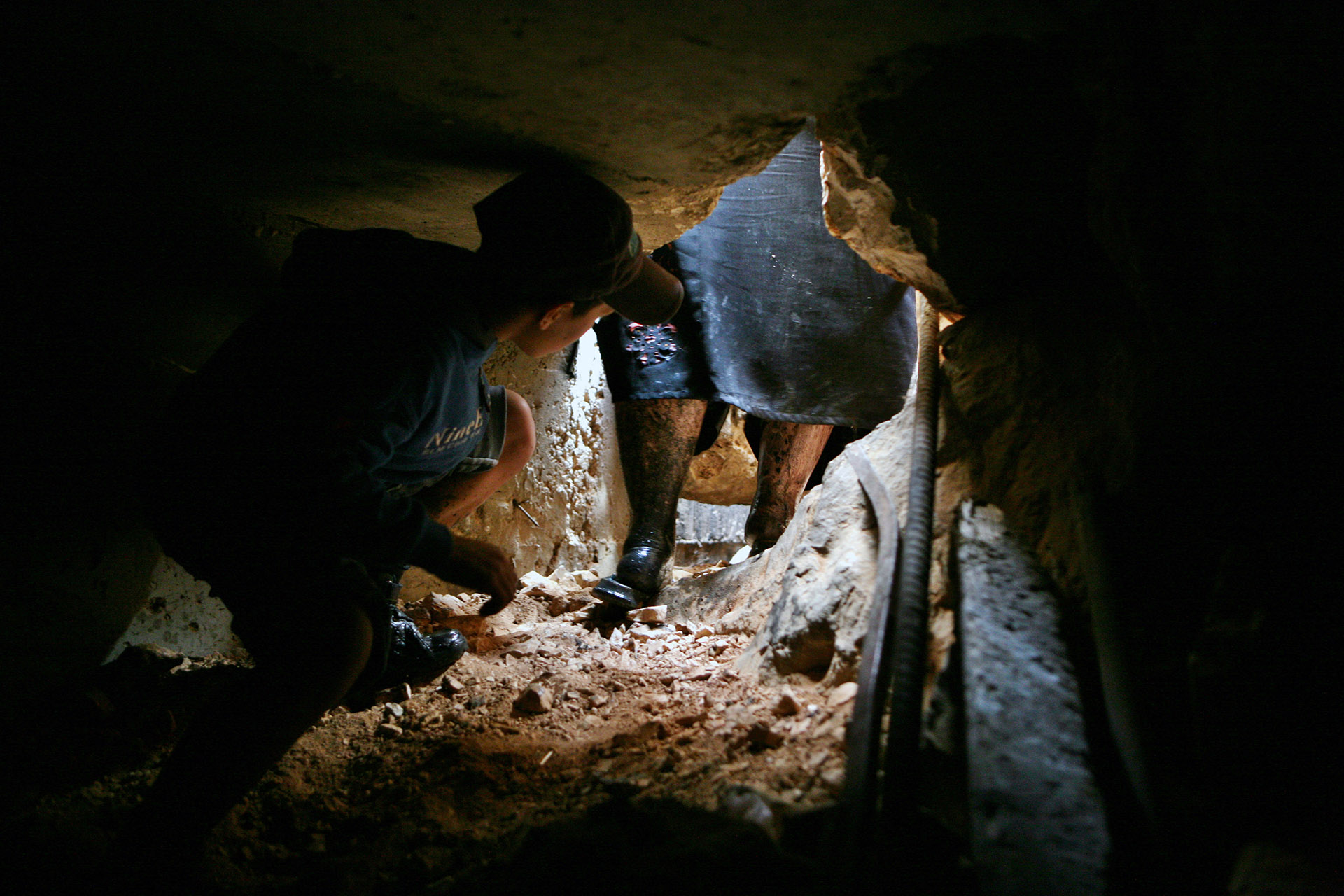 A film still shows a chjild crouched inside a cave
